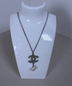 Chanel B16V CC faux pearl drop pendant necklace displayed on a white bust