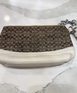 Alternative view of Coach Signature Canvas Wristlet featuring a classic tan and brown monogram pattern with white leather trim