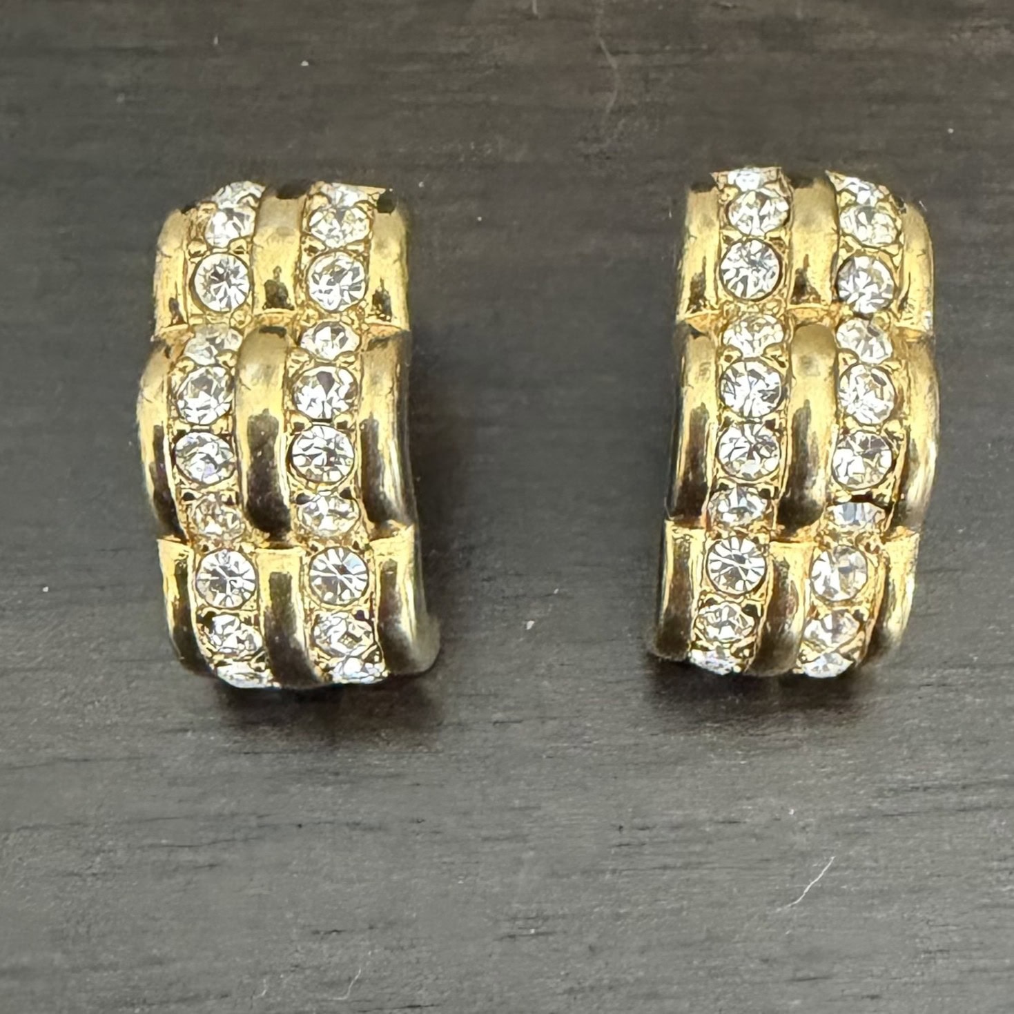 Swarovski crystal half-hoop earrings.