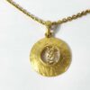 Vintage Yves Saint Laurent Gold Tone Hammered Round Cutout YSL Logo Pendant Necklace