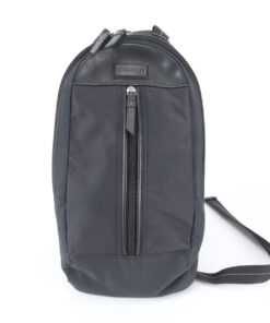 Front view of Coach black nylon and leather sling pack