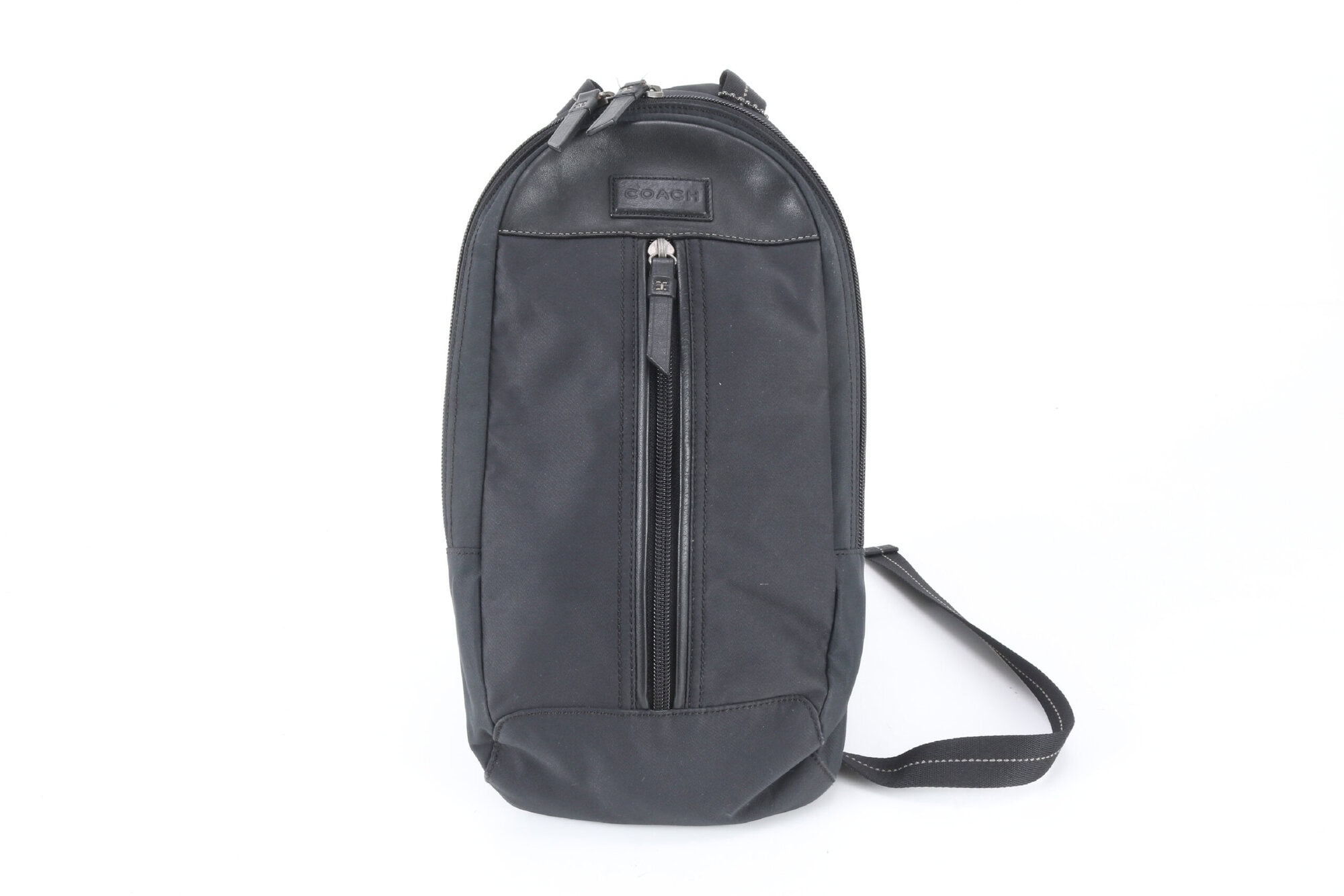 Front view of Coach black nylon and leather sling pack