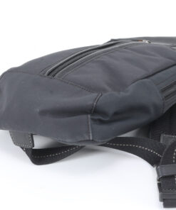 Close-up of opposite base corner on Coach black sling pack