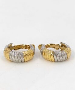 Pair of Givenchy two-tone gold-tone and silver-tone ribbed hoop clip-on earrings standing upright on a white surface.