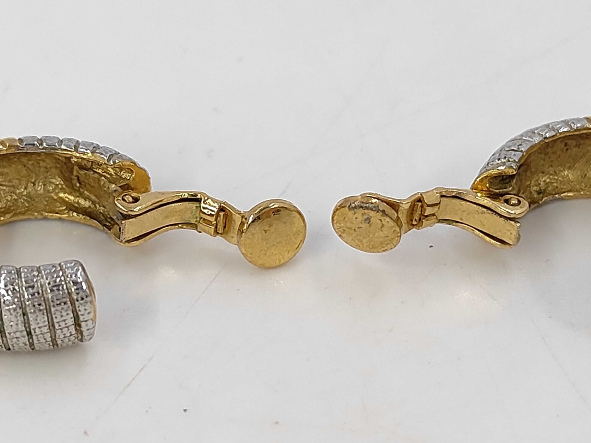 Close-up of the round contact pads on the paddle clips of the Givenchy clip-on earrings.