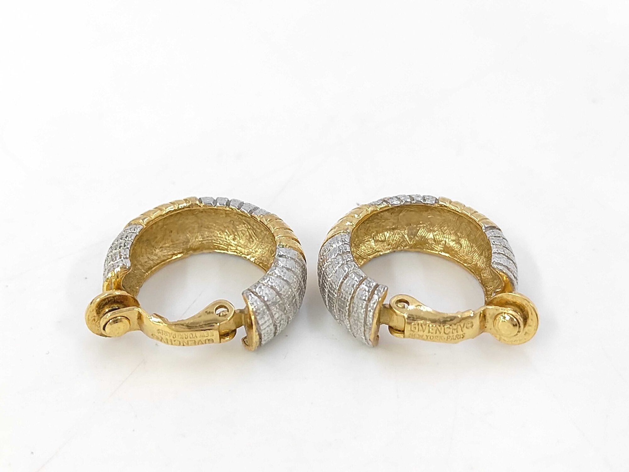 Rear view of Givenchy ribbed hoop clip-on earrings showing open-back construction and stamped paddle clips.