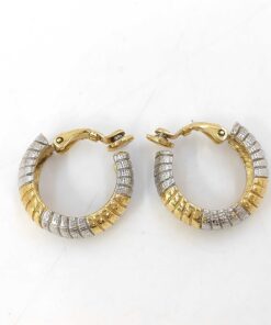 Side profile of Givenchy two-tone ribbed hoop clip-on earrings showing curved half-hoop silhouette and clip hinges.