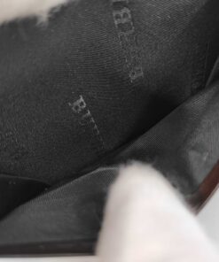 Interior gusseted card compartment lined in black Burberry logo jacquard textile.