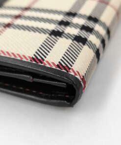 Close-up of corner fold and edge glazing on Burberry Nova Check card case.