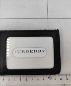 Reverse view of Burberry card case with clear ID window shown against a centimeter measuring mat.