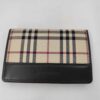 Front view of Burberry folding card case featuring Nova Check canvas and debossed dark brown leather trim.