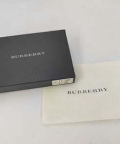 Burberry presentation box with label sticker alongside branded dust cloth.