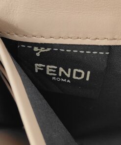Close-up of black interior fabric tag with woven Fendi Roma signature.