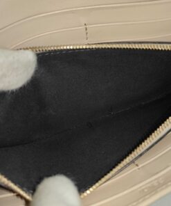 Open view into dark fabric interior of central zip coin pocket.