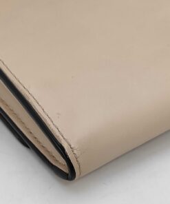 Corner detail of Fendi pink leather flap wallet highlighting black edge glazing.