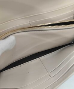 Overhead view of expanded interior compartments, central zip pocket, and card slots.