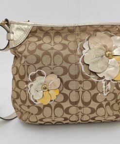 Front view of Coach khaki signature canvas shoulder bag with metallic gold leather trim and multi-layered leather floral appliqués.