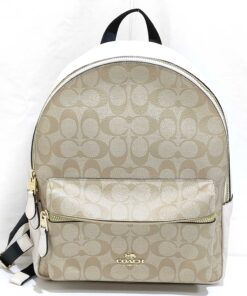 Front view of Coach Medium Charlie backpack in khaki signature canvas and chalk white leather