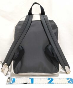 Back panel of Coach backpack with padded shoulder straps and ruler along base