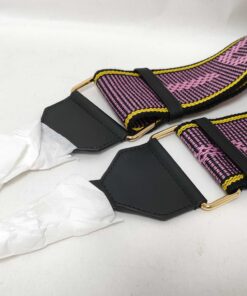 Back angle of black leather end tabs with gold-tone hardware loops and tissue-wrapped clips.