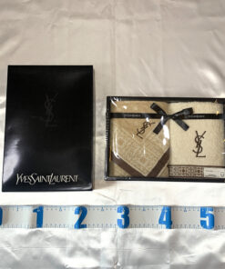 Yves Saint Laurent boxed towel set shown alongside measuring tape