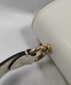 Top panel view of Coach satchel showing gold-tone ring mounting for the carry handle