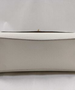 Bottom base of Coach satchel in chalk white crossgrain leather with four protective gold-tone feet