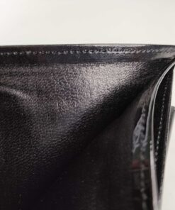Top view inside the open billfold compartment of the black leather wallet