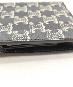 Bottom edge view of Celine Triomphe canvas bifold wallet displaying folded structure.