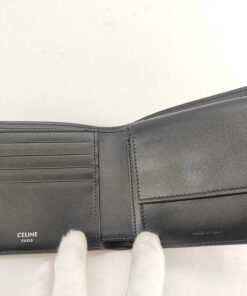 Open interior view of Celine wallet showing card slots, coin flap, and logo stamps.