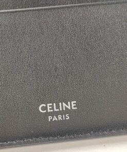 Macro view of silver foil Celine Paris logo stamped on black leather interior.