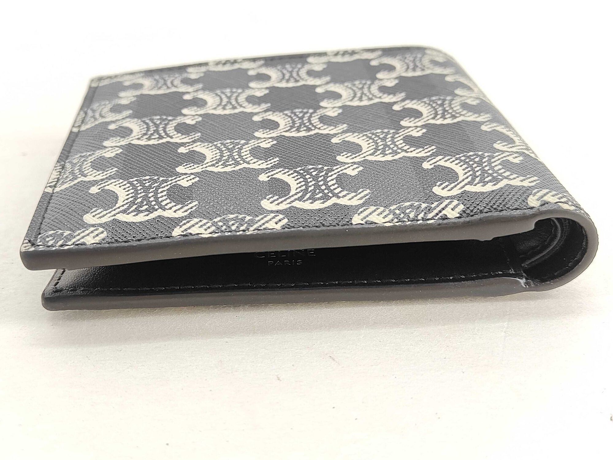 Top edge view of Celine Triomphe bifold wallet showing currency compartment opening.