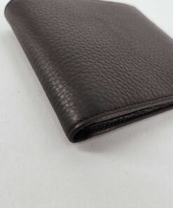 Corner angle view of closed Dunhill Black leather wallet showing folded spine.