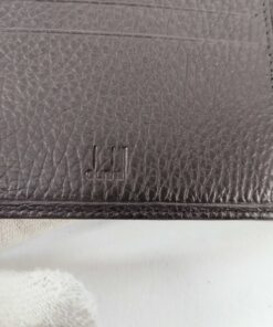 Close-up of debossed Dunhill brand mark on interior Black leather card panel.