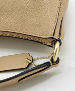 Close-up of shoulder strap ring attachment and Coach leather hangtag