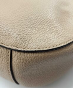 Close-up of base corner on pale gold pebble leather showing minimal contact wear
