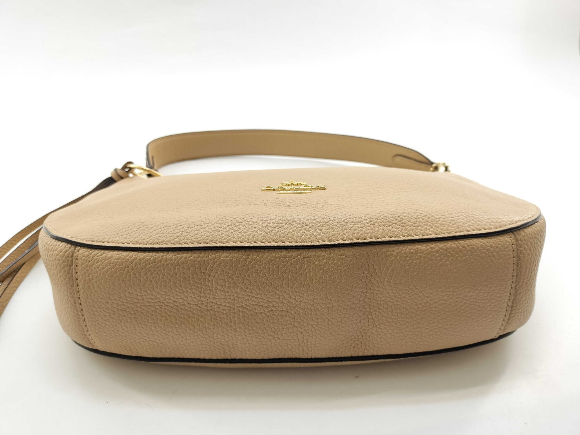 Bottom base panel view of Coach Sutton pale gold leather shoulder bag