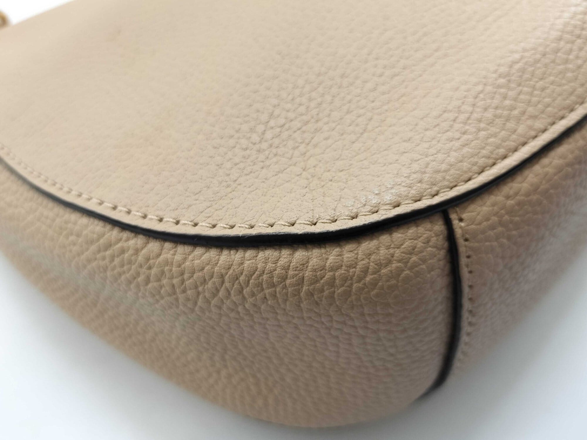 Close-up of bottom corner and edge stitching on pale gold pebble leather