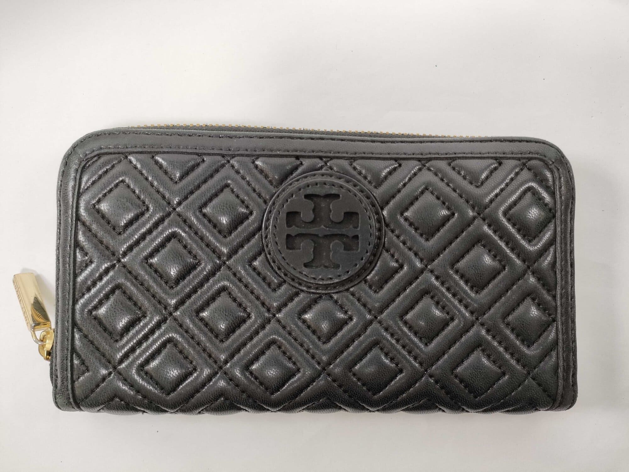 Front view of black quilted leather Tory Burch Fleming continental wallet with Double T logo medallion.