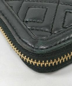 Close-up of bottom corner on black quilted leather Tory Burch wallet showing light edge wear.