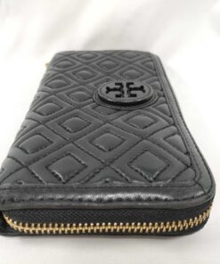Side profile of black quilted leather Tory Burch wallet showing gusset fold and zipper end.