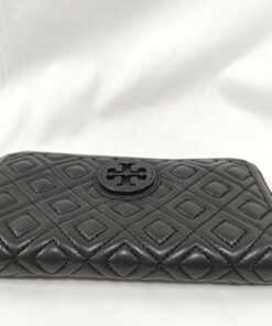 Bottom edge of black quilted leather Tory Burch continental wallet showing seam stitching.