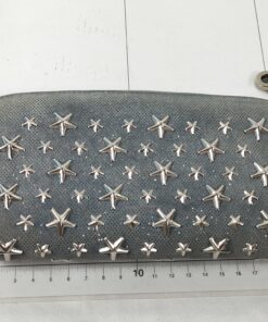 Top-down view of Jimmy Choo Filipa wallet placed on a centimeter measuring grid.