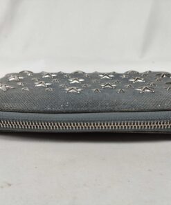 Side profile showing closed perimeter zipper track of Jimmy Choo Filipa wallet.