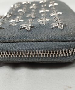 End profile view of Jimmy Choo zip-around wallet showing zipper track and corner edge.