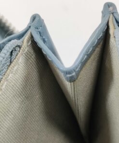 Close-up of interior accordion side gusset showing stitching and fabric lining.