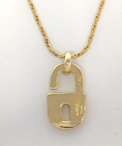 Reverse view of Christian Dior padlock pendant showing smooth finish and hallmark