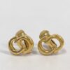 Pair of Christian Dior gold-tone interlocking CD logo clip-on earrings displayed upright from the front.