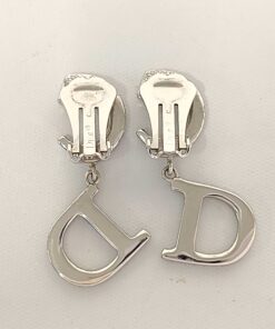 Back view of Christian Dior CD logo drop earrings displaying closed paddle clip-on backings.