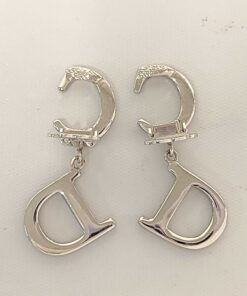 Back view of Christian Dior earrings showing open paddle clip backings and smooth metal reverse.